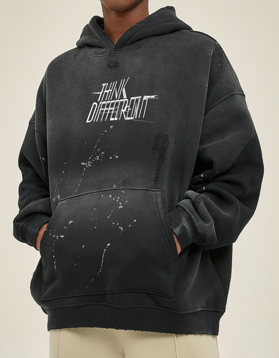 Sudadera vintage negra con capucha estilo oversize y efecto salpicado, vista frontal en modelo